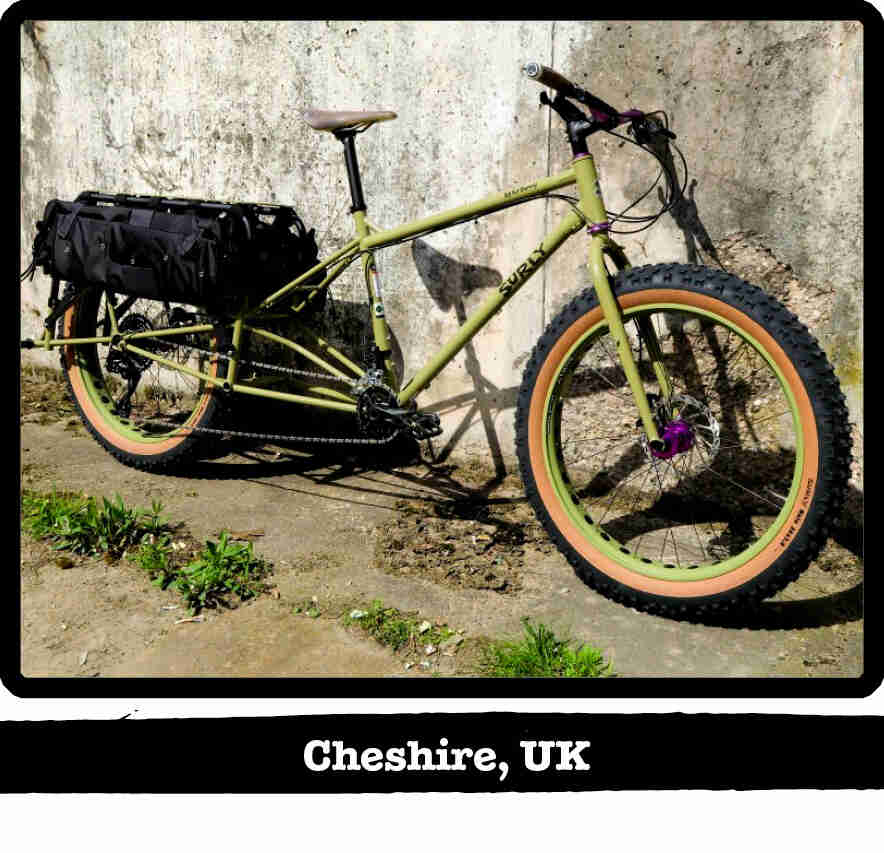 Right side view of a Surly Big Fat Dummy bike, green, against a concrete wall - Cheshire, UK tag below image