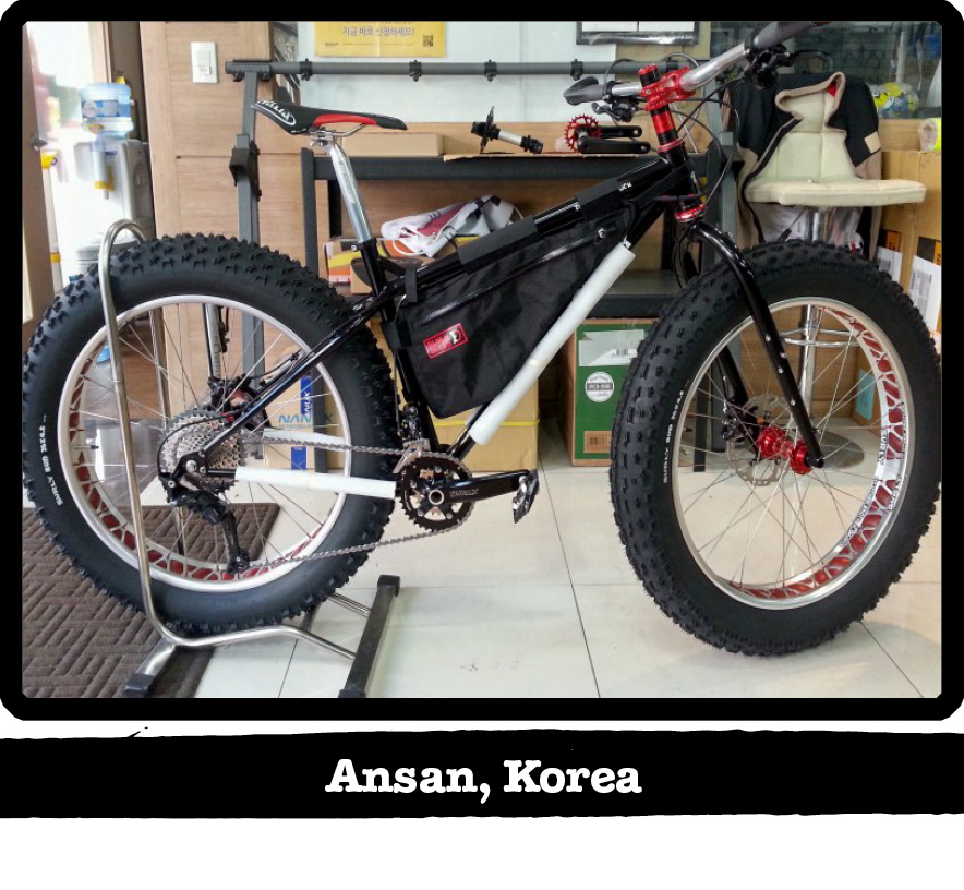 Right profile of a Surly fat bike with the back tire in a stand on an office floor-Ansan, Korea banner shown below image