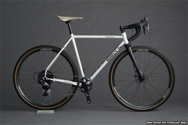 Right profile view of a Surly Midnight Special bike, white, with Whisky forks, against a gray background