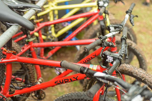 Right side view of red Surly bikes lined up