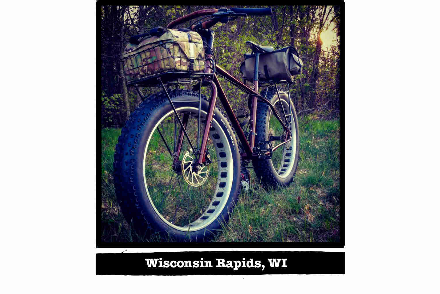 Front right view of a Surly fat bike on grass, woods in the background - Wisconsin Rapids, WI tag below image