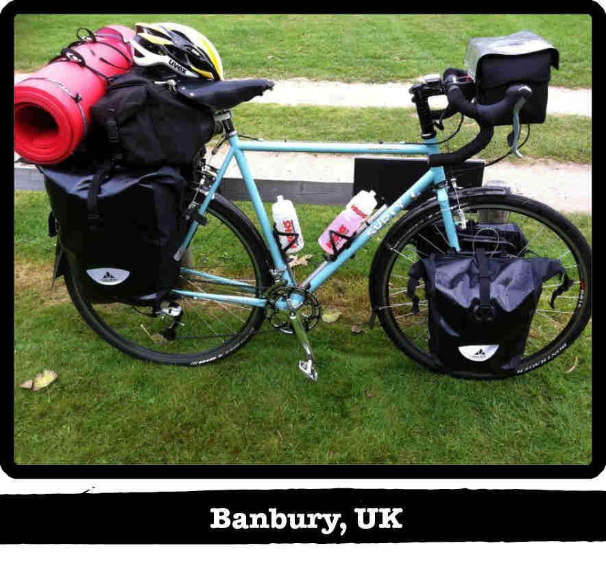 Right side view of a mint Surly bike, full of gear, standing on short green grass - Banbury, UK tag below image