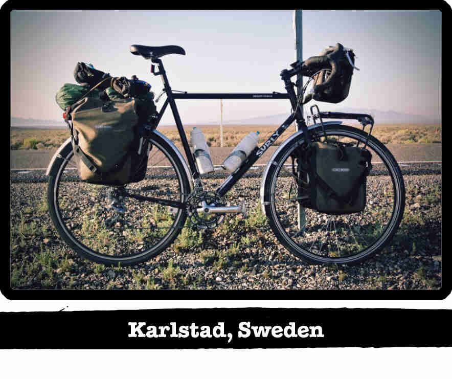 Right side view of Surly bike loaded with gear, on the shoulder of a remote road - Karlstad, Sweden tag below image