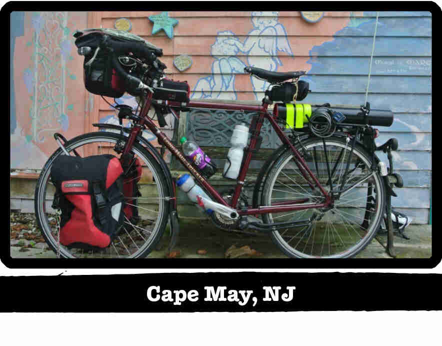 Left view of a dark red Surly bike with gear, in front pf a mural painted wall - Cape May, NJ tag below image