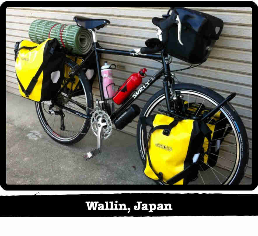 Right side view of a black Surly bike loaded with gear, leaning on a steel sided wall - Wallin, Japan tag below image