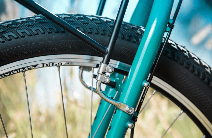 Surly 8-Pack rack - black - mounted on a turquoise Surly bike - lower fork mount detail - left side view