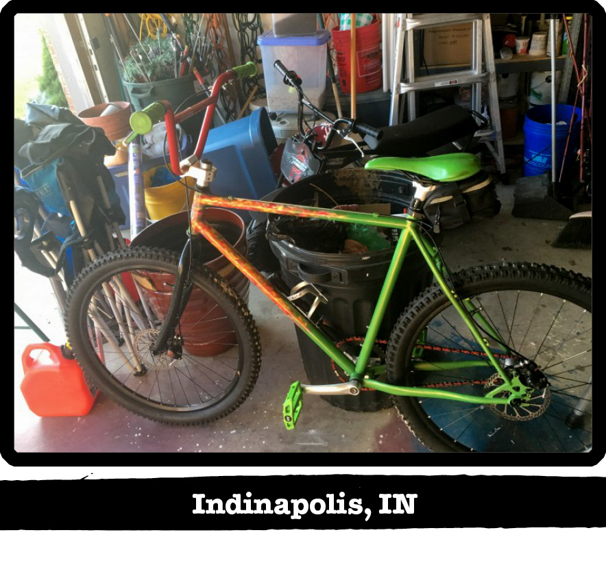 Left side view of a green and orange Surly BMX bike in a house garage-Indianapolis, IN banner below image