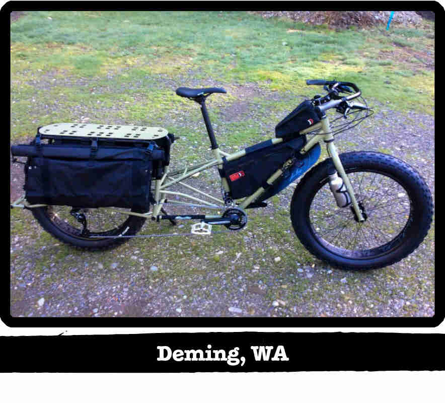 Right side view of a Surly Big Fat Dummy bike, olive, parked on gravel - Deming, WA tag below image