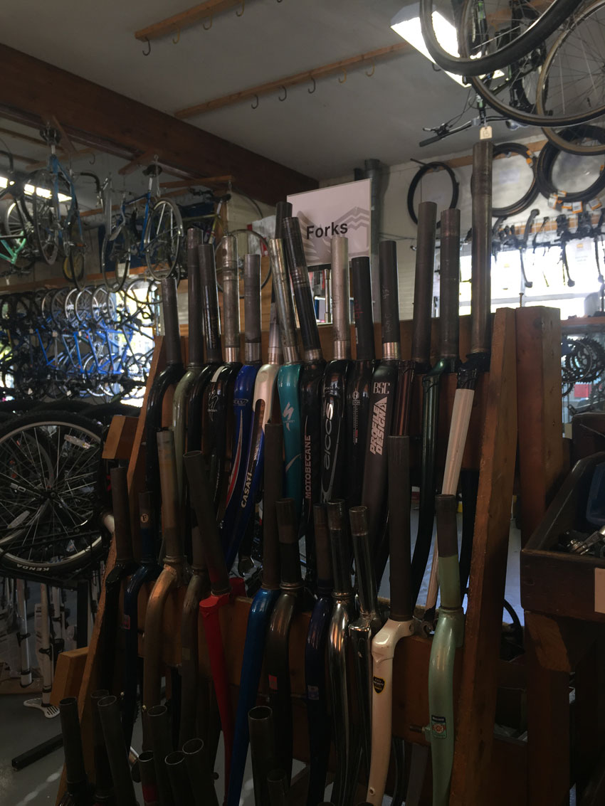 A rack of bike forks, in a bike shop