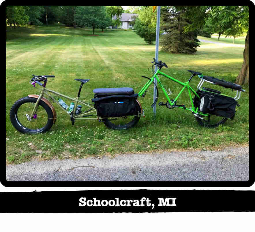 Left side view of a Surly Big Fat Dummy bike, green, with a bike attached to the back - Schoolcraft, MI tag below image