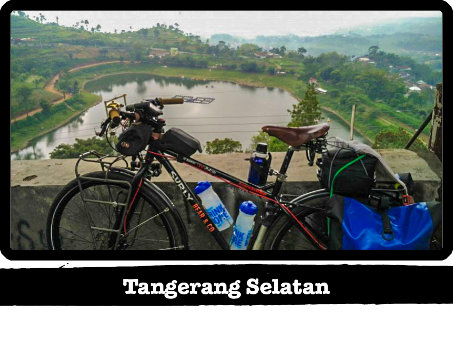 Left side view of a Surly Karate Monkey bike, black, with pond in background - Tangerang Selatan tag below image