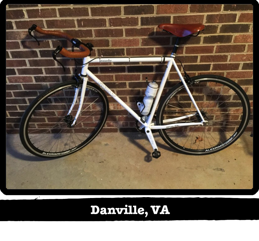 Left side profile of a while Surly bike leaning against a brick wall - Danville, VA banner under image
