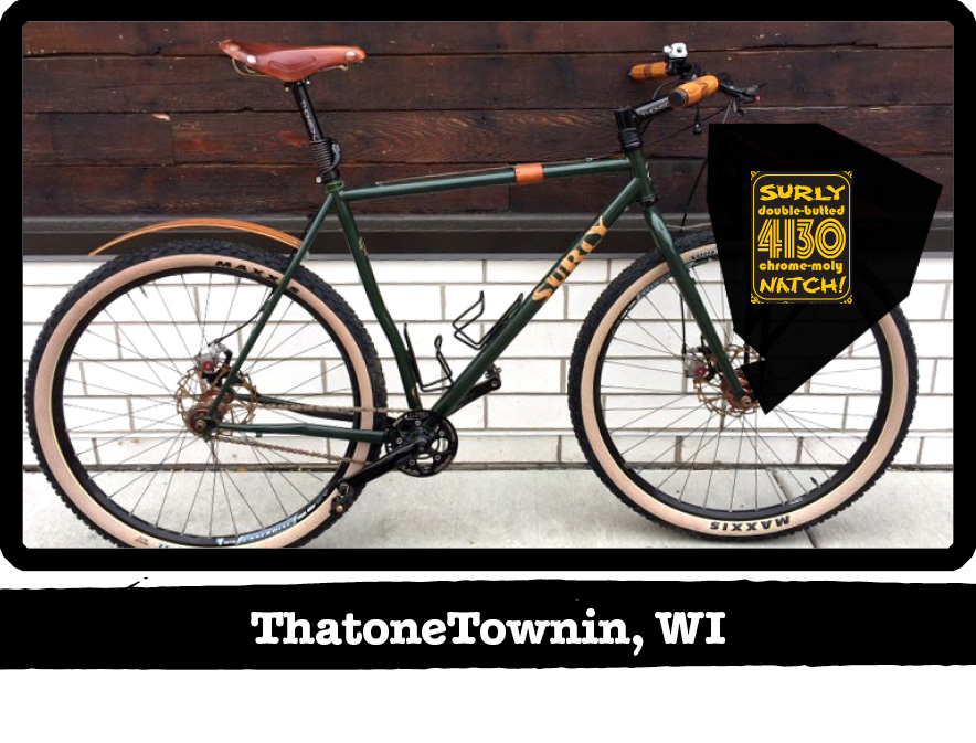 Right profile of a green Surly bike against a white brick and wood wall-ThatoneTownin, WI banner shown below image