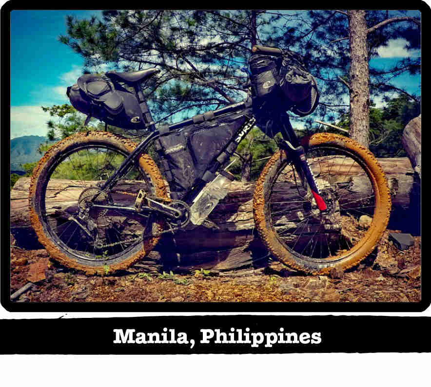 Right profile of a Surly Karate Monkey bike, black, with muddy tires - Manila Philippines tag below image