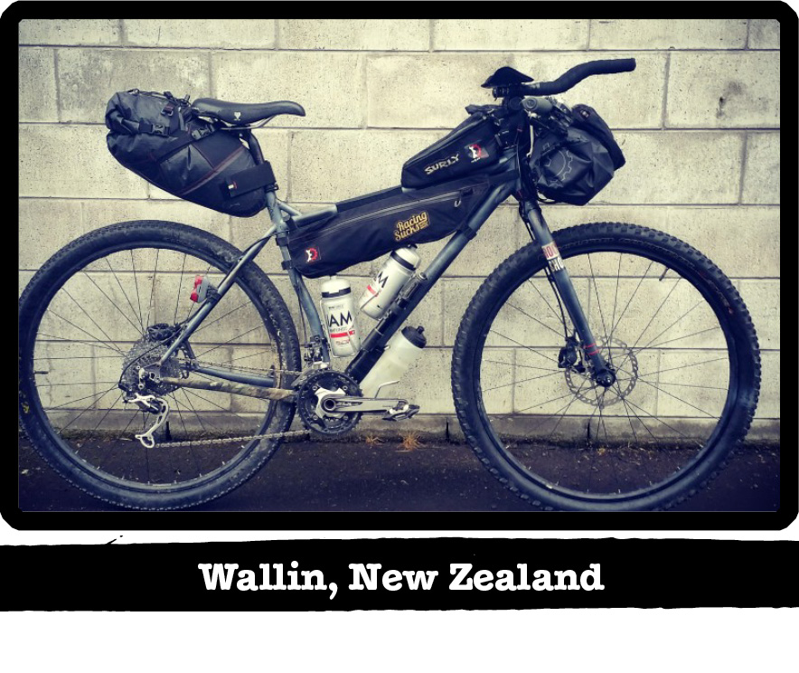 Right profile of a gray Surly bike on a sidewalk with a cinder block wall behind-Wallin, New Zealand banner below image