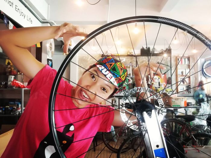 Immu building a bicycle wheel on a truing stand