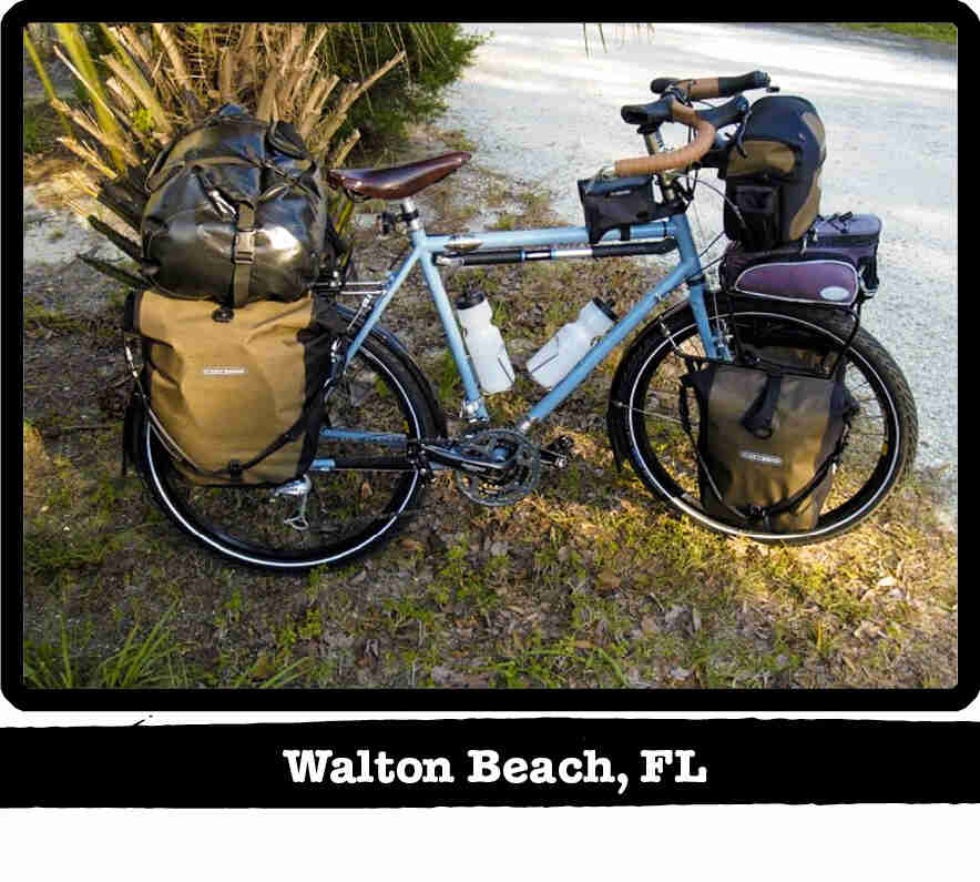 Right side view of a light blue Surly Long Haul Trucker bike, loaded with gear - Walton Beach, FL tag below image
