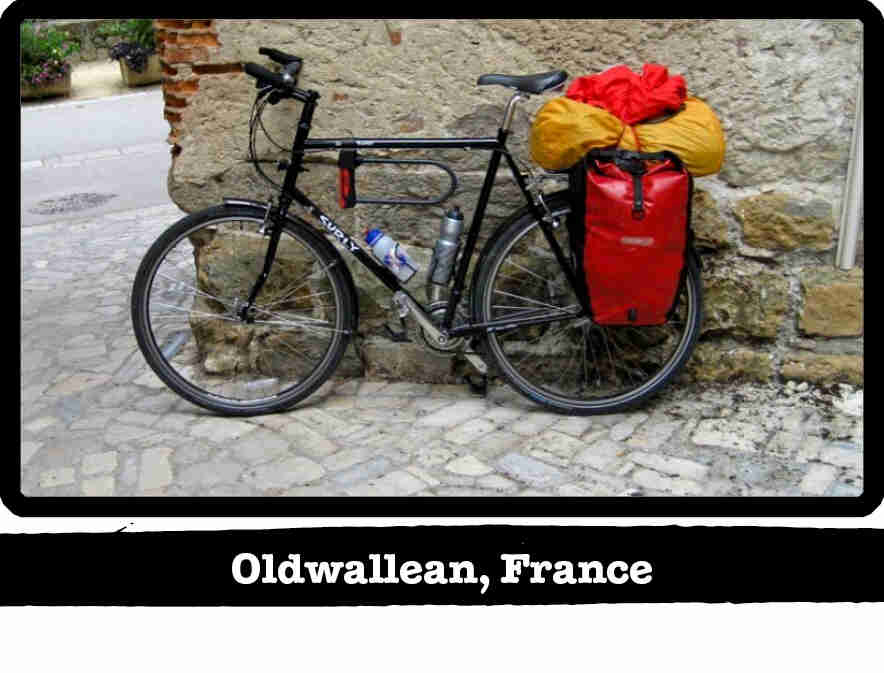Left side view of a black Surly Long Haul Trucker bike loaded with gear - Oldwallean, France tag below image