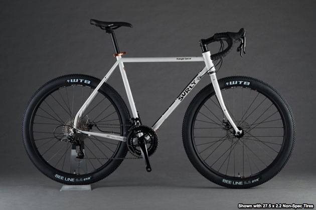 Right profile view of a Surly Midnight Special bike, white, against a gray background