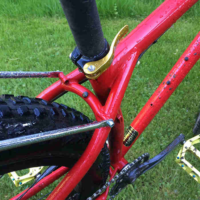 Downward close up view of the seat post, clamp, tube and seatstay of a Surly Krampus bike, red