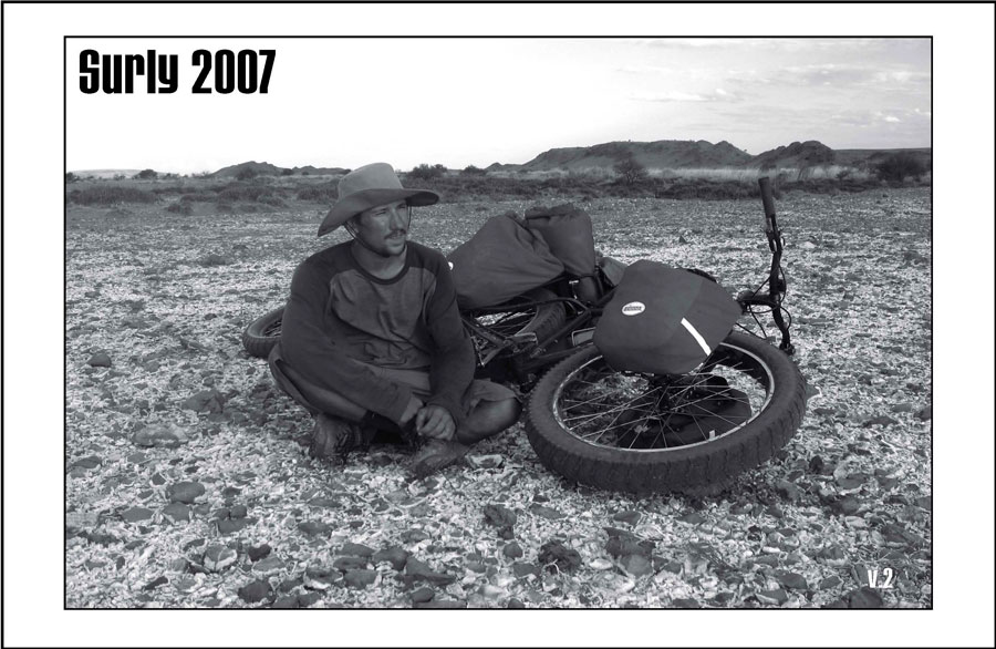 Surly Bikes - 2007 Catalog Cover - A cyclist, wearing a cowboy hat, sitting in the desert with a Surly fat bike