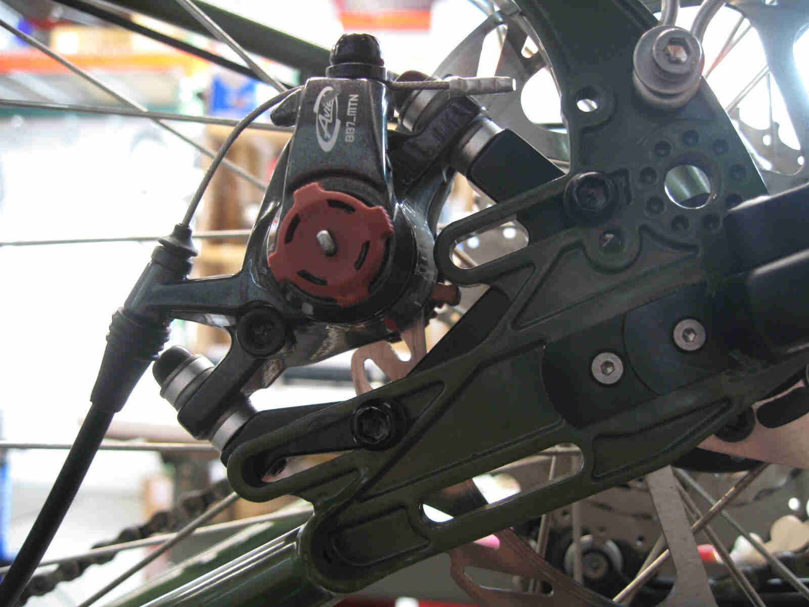 Surly Ogre bike - green - rear disc brake caliper detail - left side, close up view