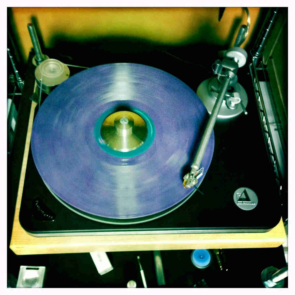 Downward view of a blue record album on a turntable
