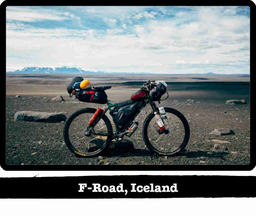 Right side view of a Surly bike, loaded with gear, on a flat gravel tundra - F-Road, Iceland tab below image