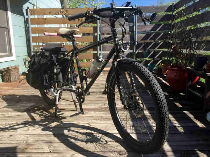 Front left side view of a Surly Big Dummy bike, parked on a deck at house
