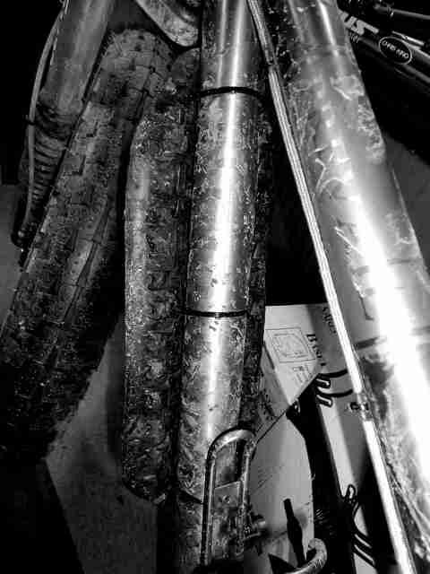 Close up, downward, left side view of a dirty fat bike - black & white image