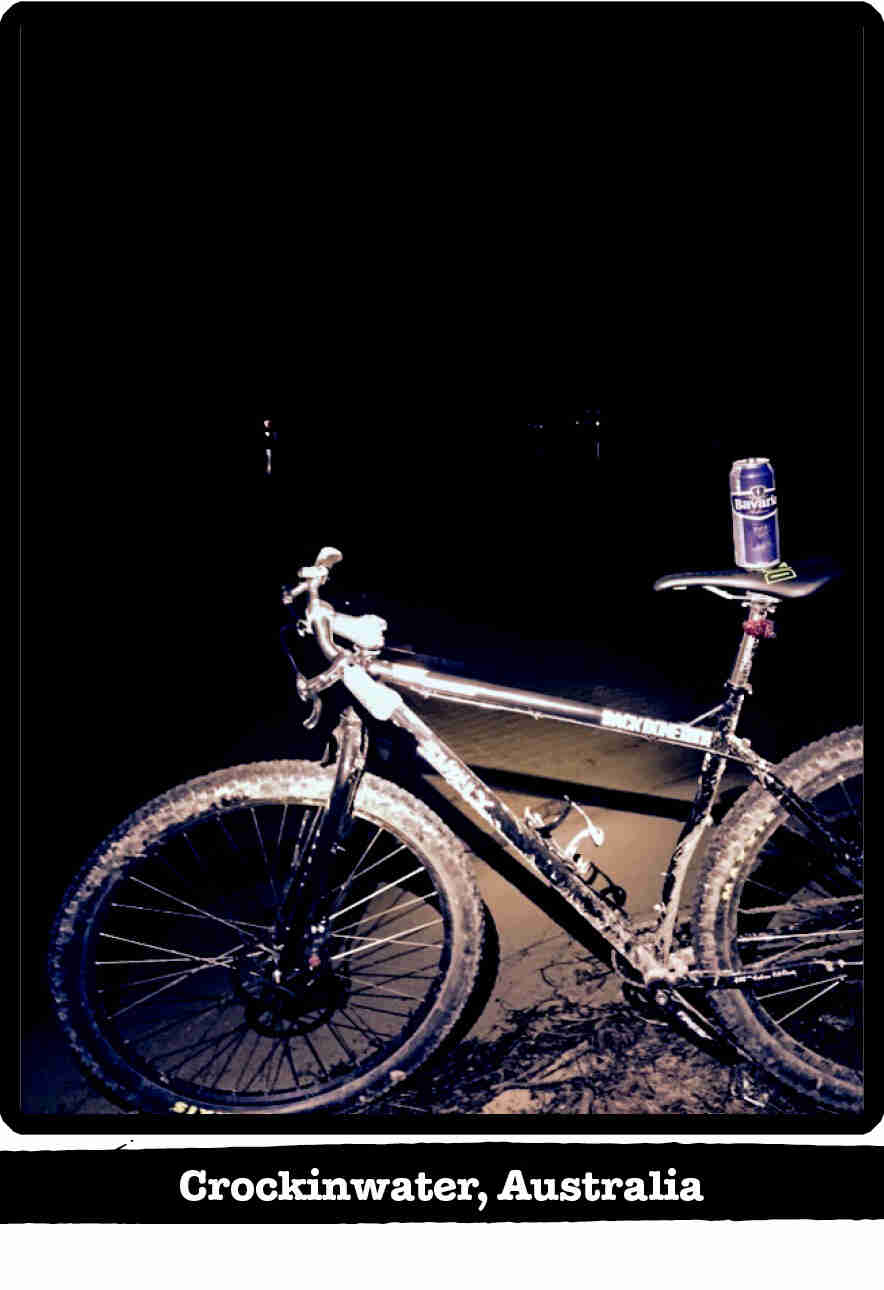 Left side view of a Surly Karate Monkey bike, black, at night in the sand - Crockinwater, Australia tag below image