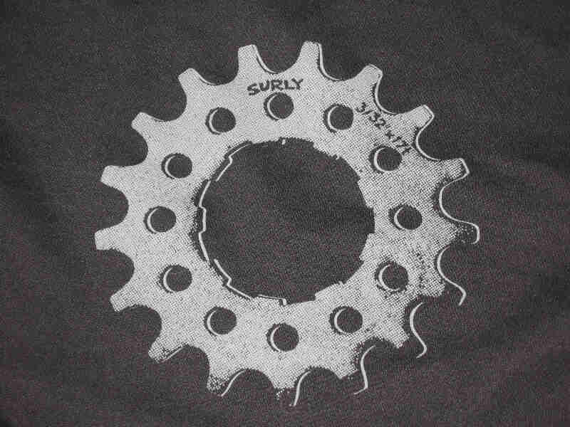 Close up view of a gray bike gear graphic from the back of a black Surly Full Zip Hoodie